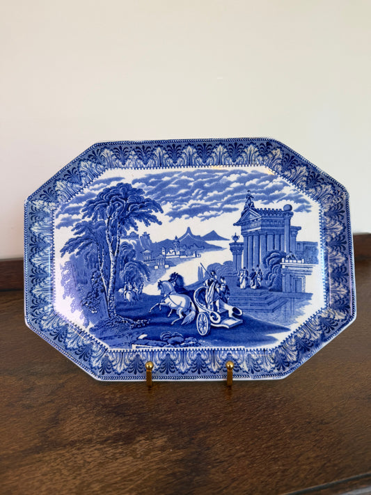 Early 20th century Cauldon England blue and white transferware octagonal serving platter featuring a classical landscape scene on a wooden sideboard.