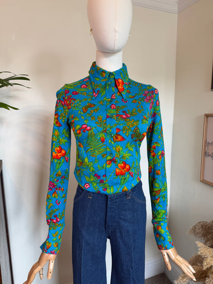 Vintage 1970s TGL Stockholm turquoise botanical print shirt with colourful floral, fruit, berry and butterfly pattern, point collar and long sleeves.