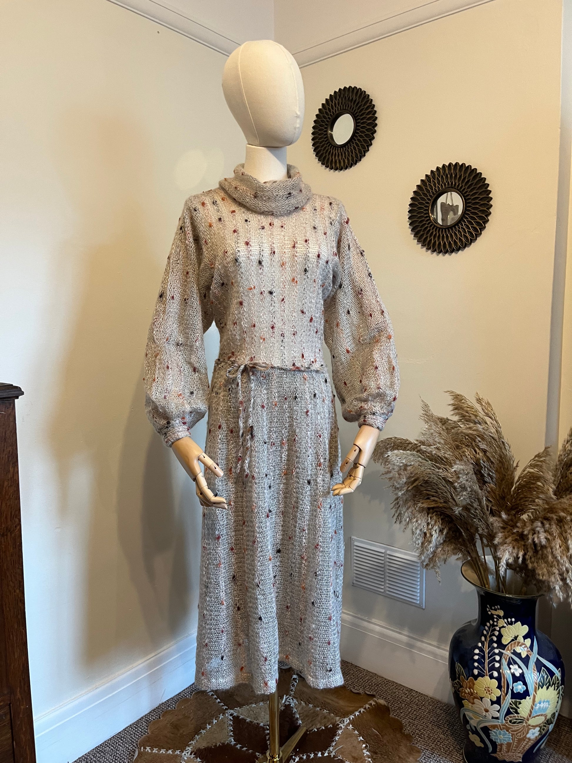 Vintage 1970s cowl neck hand knitted jumper dress With bishop  sleeves and a dropped waist tie in grey and multi colour spots made from mohair and wool blend 
