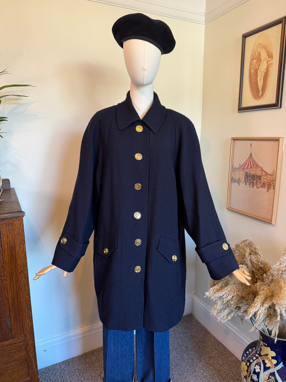 Vintage Jaeger navy blue pure wool coat made in Great Britain, featuring gold-tone buttons, a classic collar, front flap pockets and a full navy lining.