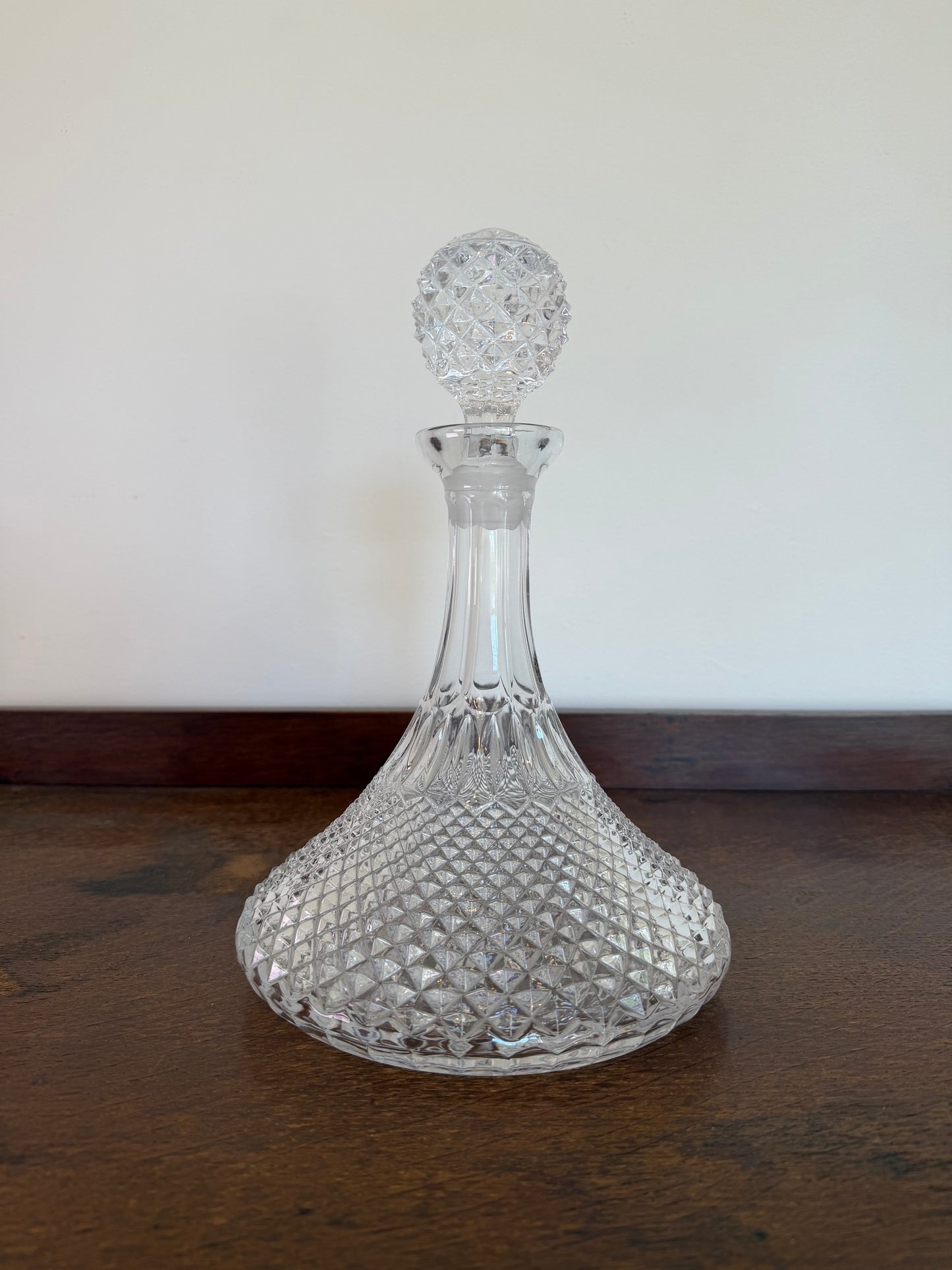 Vintage pressed glass ship’s decanter with moulded diamond pattern and matching faceted glass stopper.