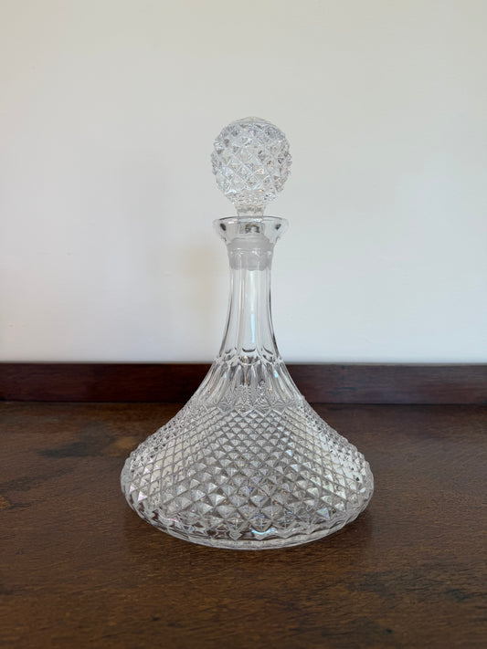 Vintage pressed glass ship’s decanter with moulded diamond pattern and matching faceted glass stopper.
