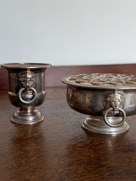 Vintage silver-plated lion head flower frog bowl with matching pedestal bud vase featuring ring handles.
