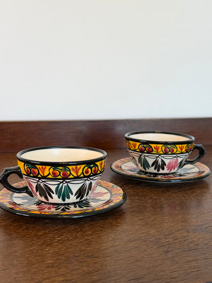 Pair of vintage French hand-decorated tea cups and matching saucers dated 1959 with colourful folk-art floral decoration.